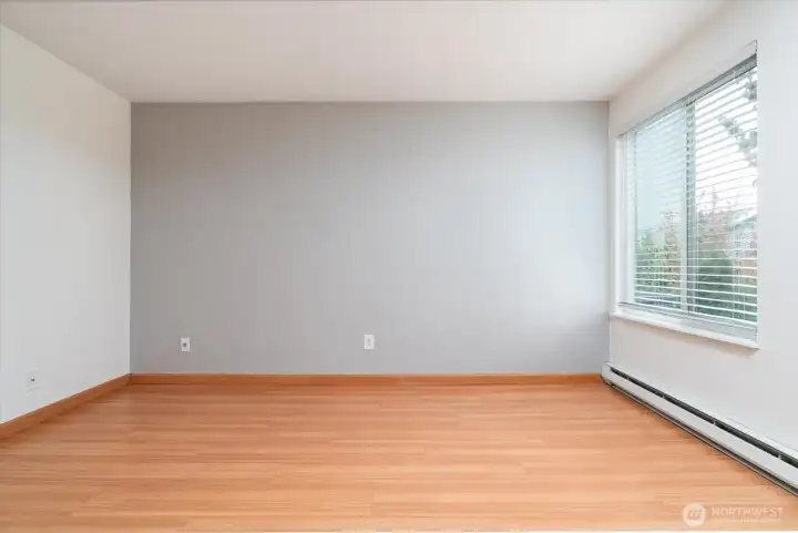 Spacious primary bedroom filled with beautiful natural light.