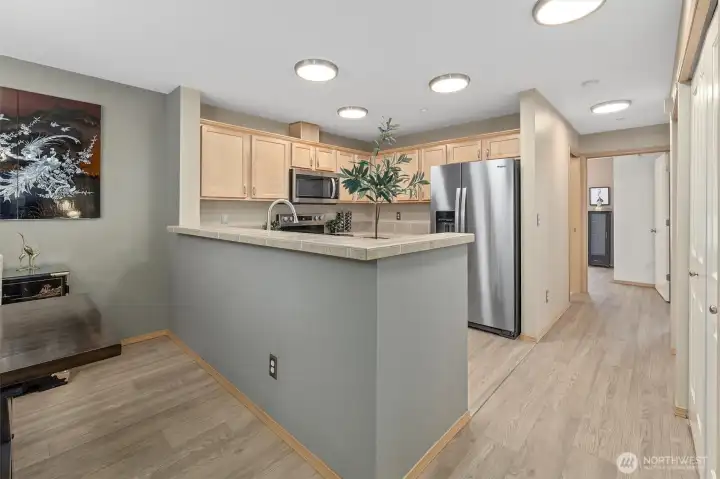 Kitchen with high eating bar, brand new stove and fridge.