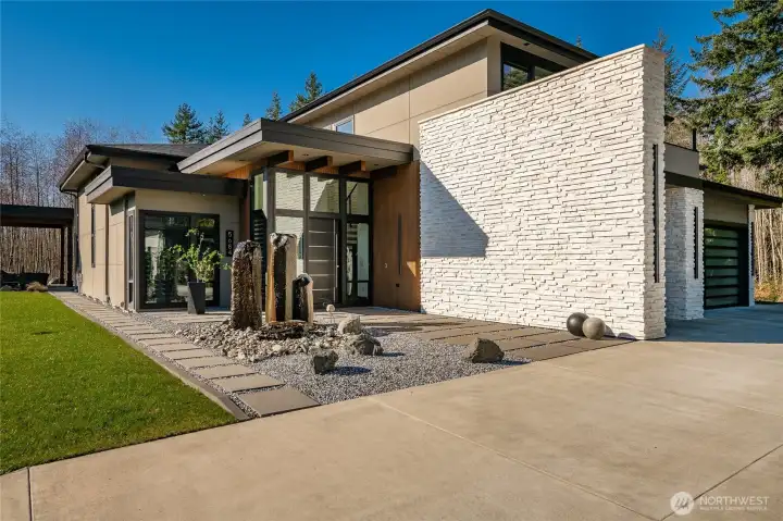 Exterior custom water feature and front entryway.