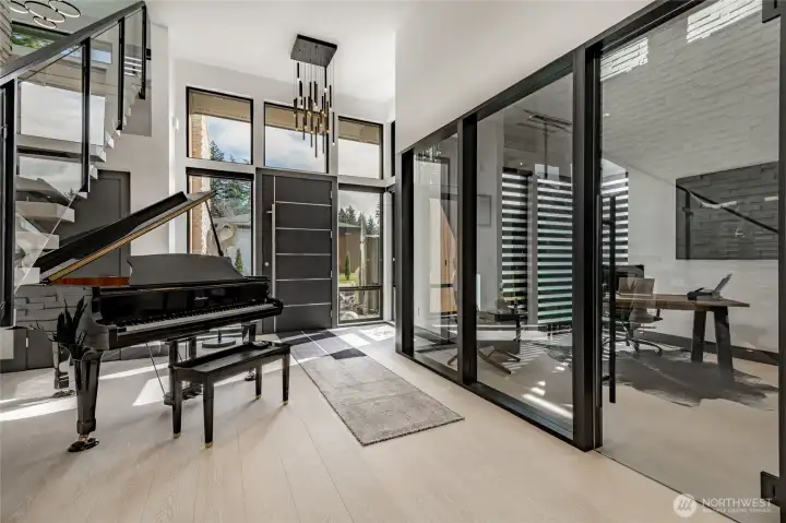 Entryway with floor to ceiling glassed-in office.