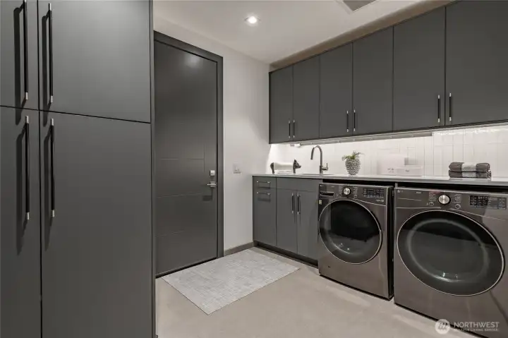 Laundry room has LG Washer/Dryer (Thin Q) with tons of storage and access to your three car garage.