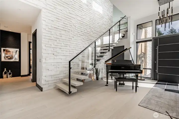Staircase leading to TV/game room with wet bar, and guest suite.