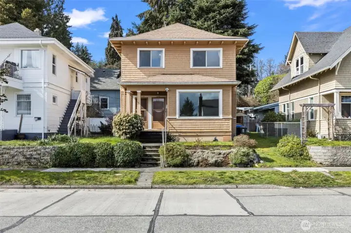 Main unit is the lower level through the right front door - large window is the living room.  Two upper windows are the living room and bedroom of the upper unit, accessed by front door on the left.