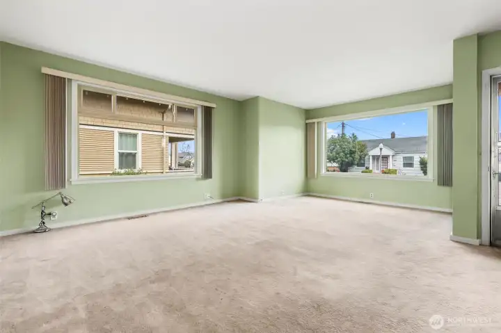 Huge windows emit incredible light in the main unit living / dining room
