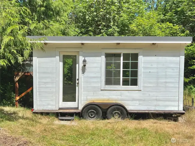 Front of tiny home. Notice the rain collection system on the left-hand side.
