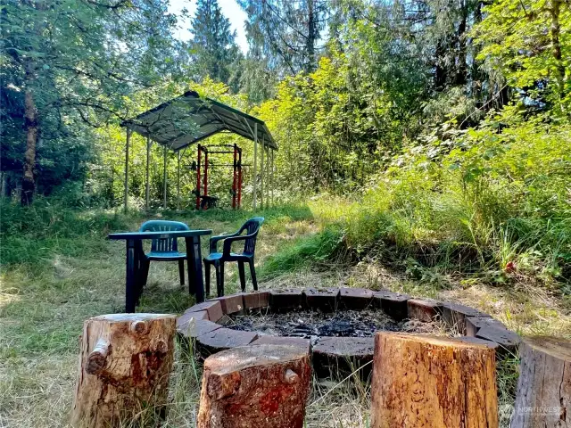 Firepit and an additional shelter comprised of slab with metal roof.