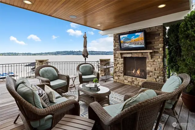 Wraparound deck off the living room with fireplace & mounted TV