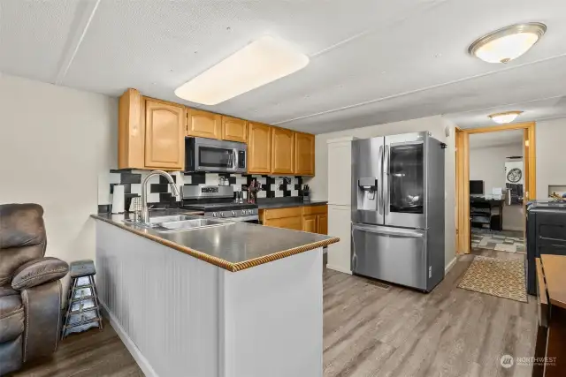 Open concept kitchen with brand new appliances.