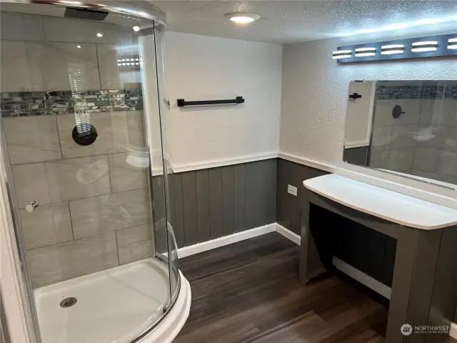 Walk in shower with dressing area.