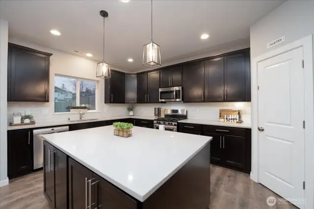 Large quartz kitchen island with extensive storage space