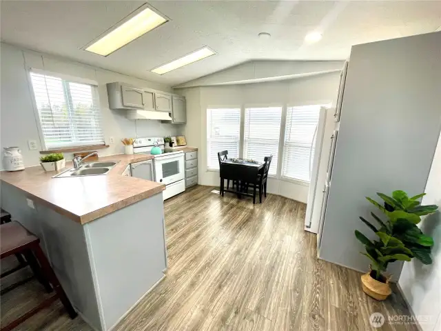 Kitchen features an eat space and newer refrigerator & oven.