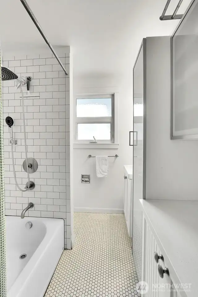 Beautiful subway tile with ample storage in the hall bath.