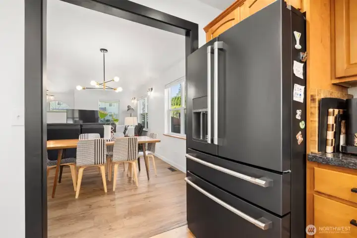 The kitchen is adjacent to the dining room and has the matte black CAFE line of appliances that were installed in 2022.