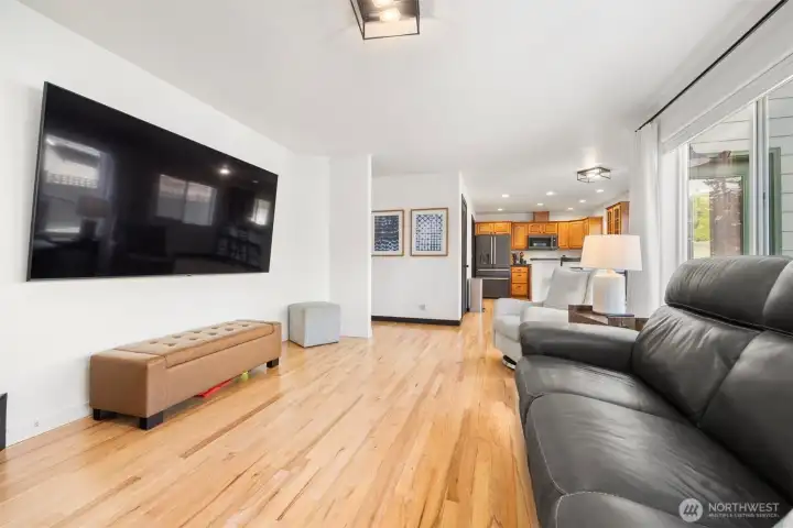 The spacious family room is open to the kitchen and also has the recently refinished hardwood floors.