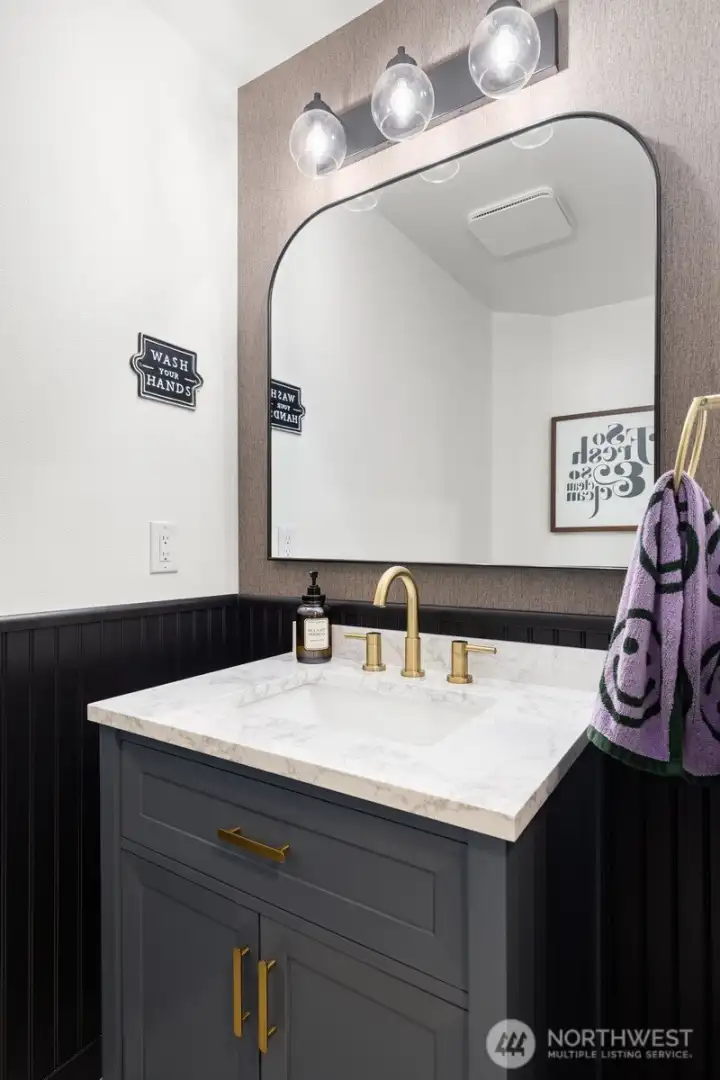 The half bath was redone in 2023 and is so chic.