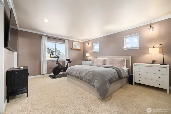 The primary suite is very spacious and has crown molding.