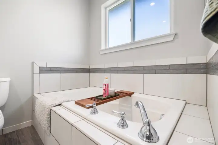 There is a deep soaking tub in the primary bath.