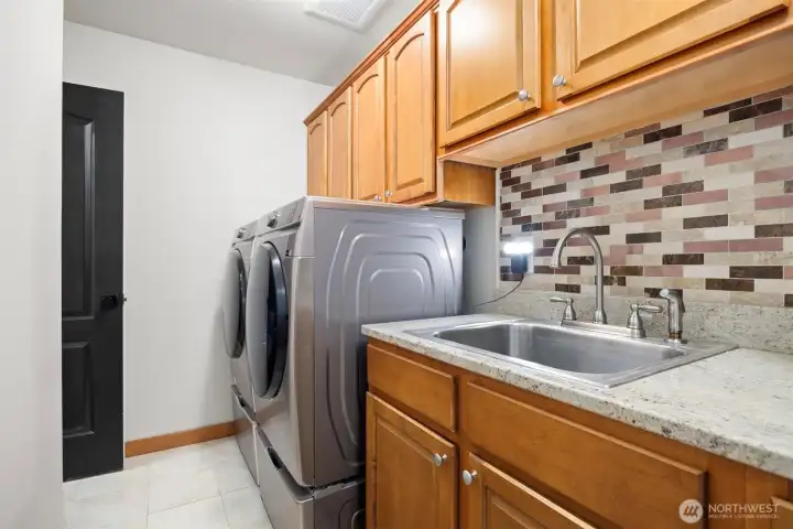The laundry room is conveniently located upstairs with the bedrooms.