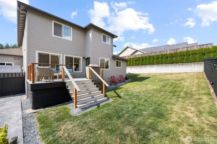 Another view of the rear yard and spacious deck that is off the kitchen and family room area.