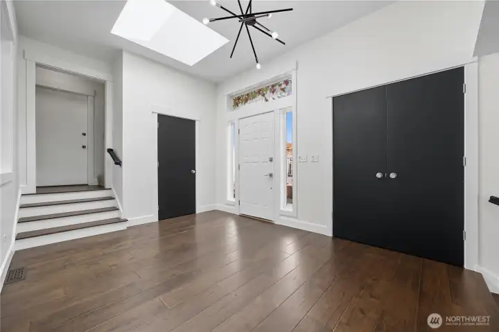 Foyer  Stylish front foyer featuring modern lighting, double closets, and a skylight that fills the space with natural light.