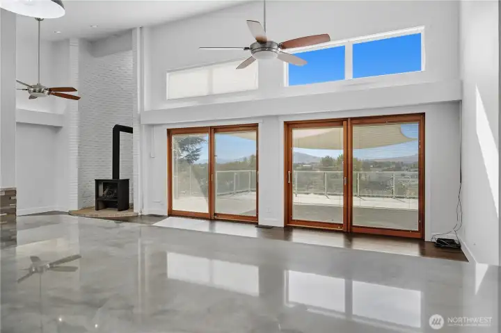 Open Concept Layout  A modern open-concept floor plan highlights high ceilings, abundant natural light, and a perfect flow between kitchen, dining, and living areas.