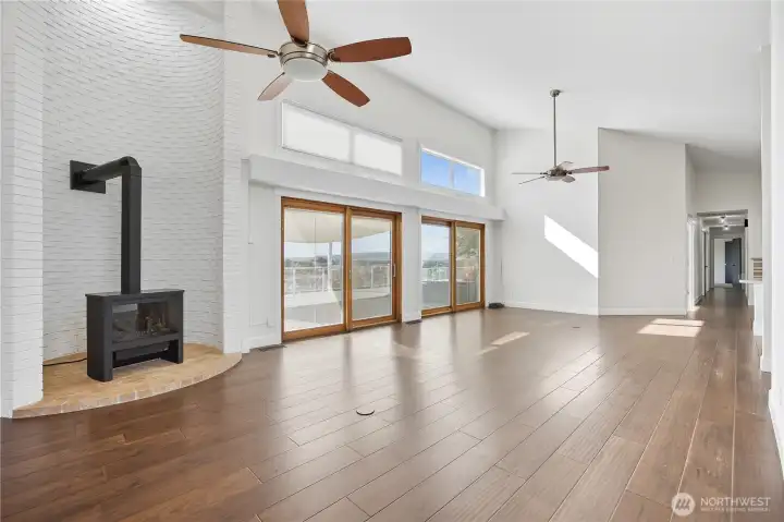 Wood-Burning Fireplace -  Striking corner fireplace with a modern black insert and white brick surround — a perfect focal point for cozy evenings.