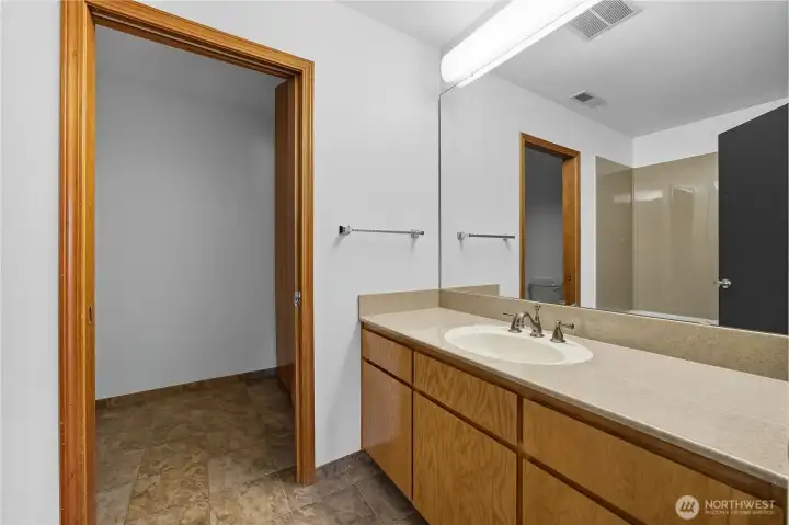 Common Bathroom 1  Well-appointed full bath with solid-surface vanity, updated fixtures, and a convenient layout connecting to the hallway.