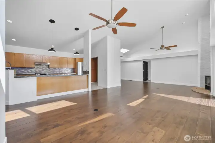 Great Room -  Expansive great room featuring soaring ceilings, dual ceiling fans, and abundant natural light streaming through floor-to-ceiling windows.
