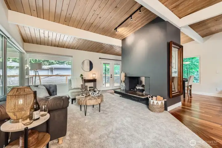 Just beyond the living and dining rooms, french doors open up to the large outdoor deck