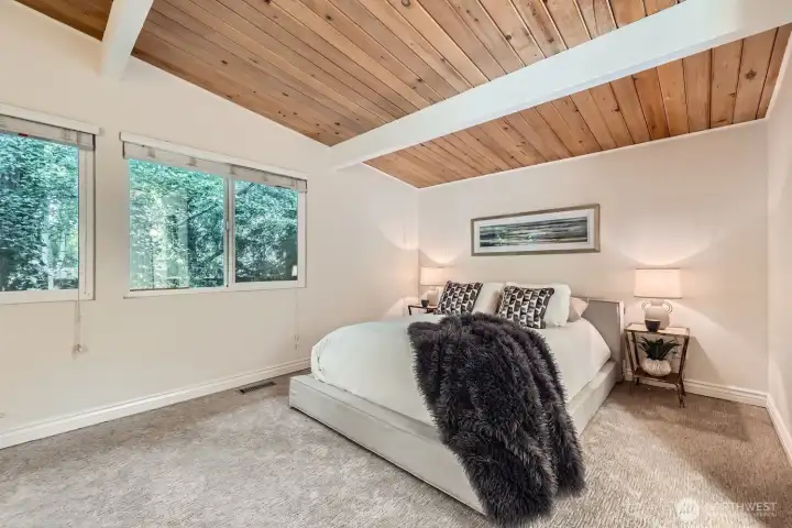 The primary suite is a tranquil retreat with private, tree-lined views