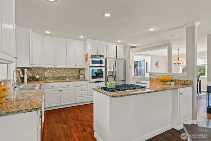 Chef's kitchen with granite counters and high-end stainless appliances. Built-in wine fridge too!