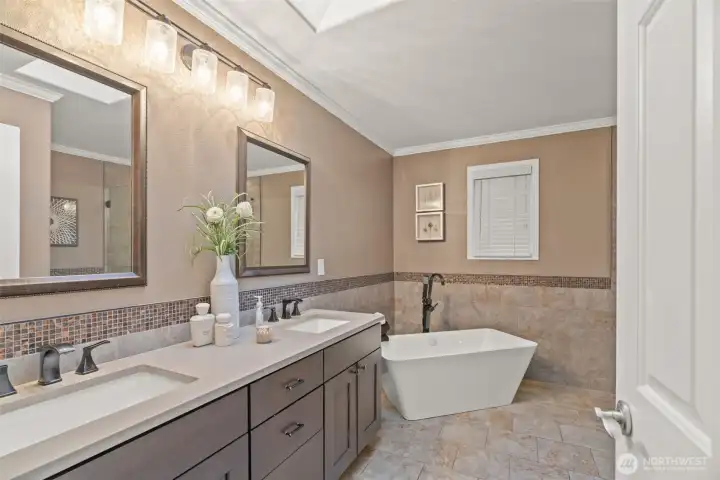 Completely updated primary bath with quartz counters, large shower and soaking tub.