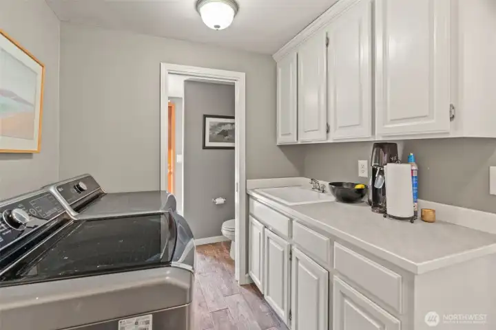 Utility room has 3rd shower, ideal for after-pool use!