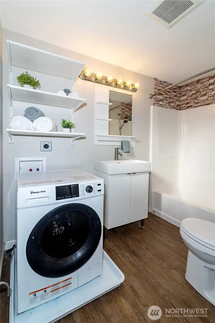 Full bathroom with dual washer/dryer combo