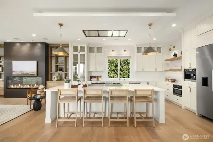 The gourmet kitchen is a masterpiece of design and function, anchored by a generous island perfect for entertaining or everyday gatherings.