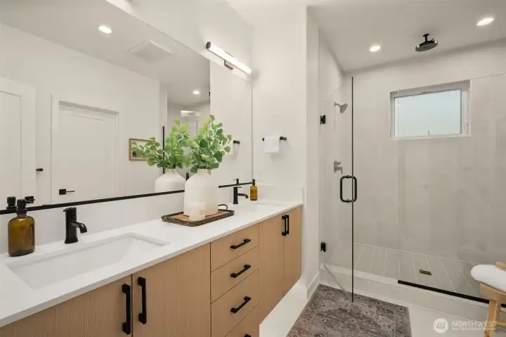 Paired with a luxury en-suite bath, features full tile surround + rainfall showerhead!