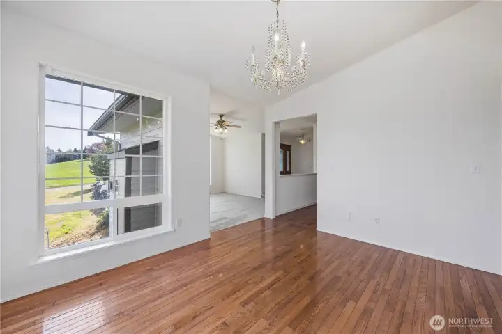 Formal dining room perfect for hosting with easy flow to kitchen and living spaces