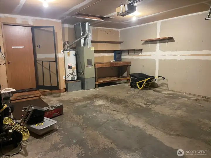 garage with force air furnace and water tank
