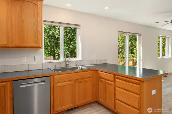 Chef's Kitchen Featuring Wood Cabinets - Breakfast Bar - Stainless Steel Appliances