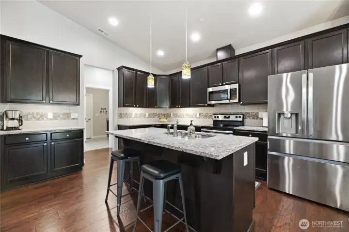 Beautiful and functional kitchen featuring granite countertops and stainless steel appliances that stay.