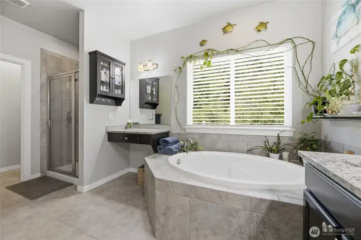 Primary ensuite features two sinks, a soaking tub, and a separate shower and vanity