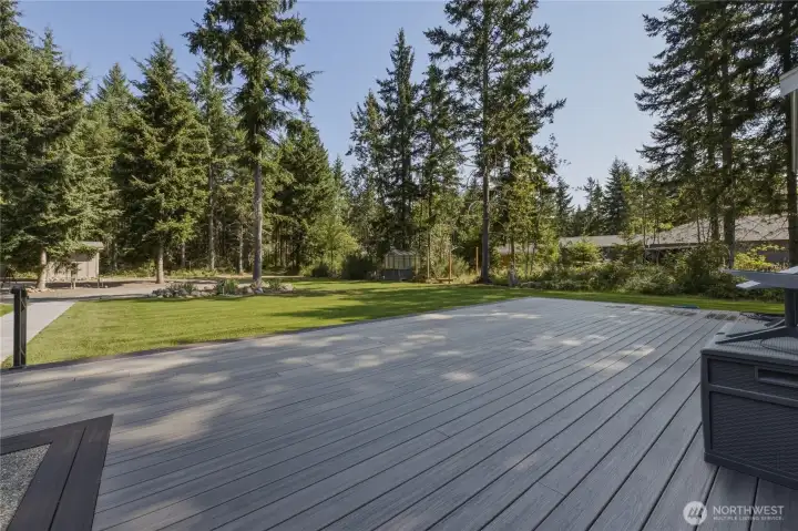 This expansive back deck and yard offers space for everyone and everything for outdoor entertaining