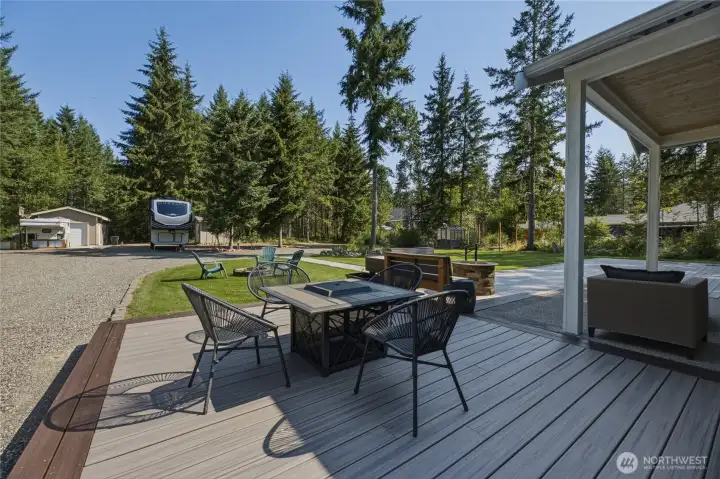 This expansive back deck and yard offers space for everyone and everything for outdoor entertaining