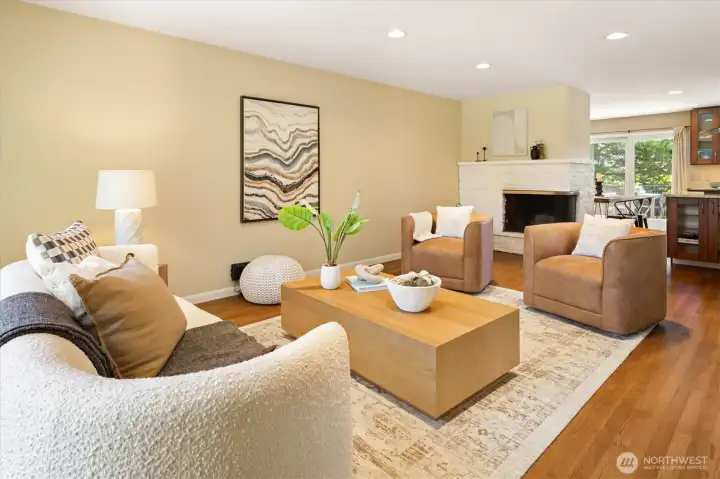 Wide and welcoming, the living room features hardwoods and a corner fireplace. Wide and welcoming, the living room features hardwoods and a corner fireplace.