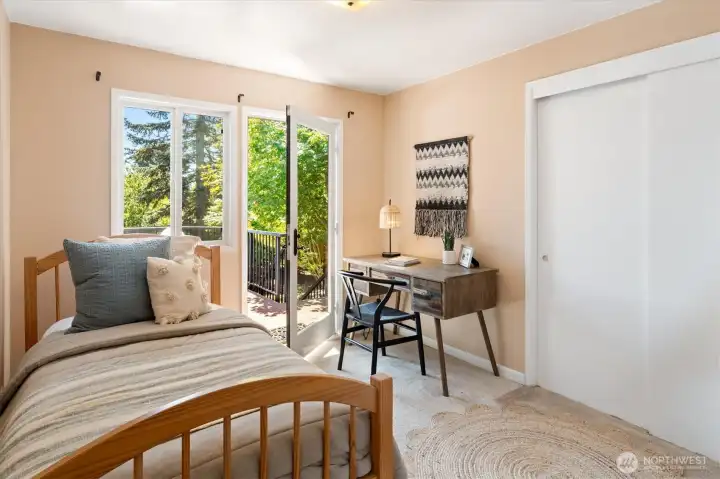 The second main floor bedroom offers hardwoods under the carpet, a large closet and deck access. The second main floor bedroom offers hardwoods under the carpet, a large closet and deck access.