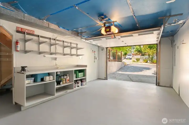 The large one car garage has extra storage area and a built in workspace. The large one car garage has extra storage area and a built in workspace.