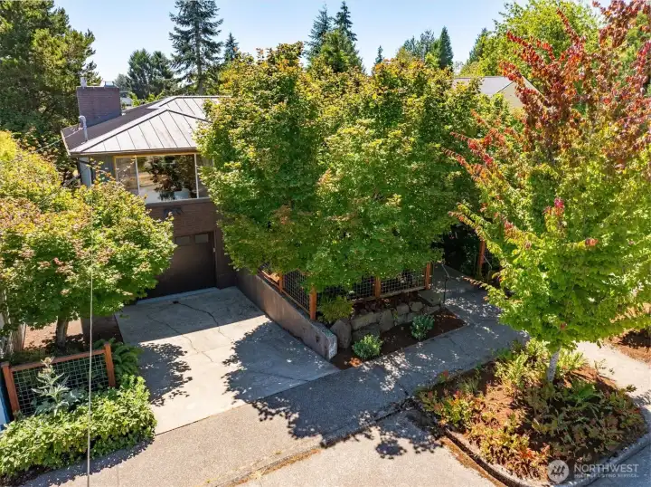 The house has amazing curb appeal, mature landscaping and features a metal roof. The house has amazing curb appeal, mature landscaping and features a metal roof.