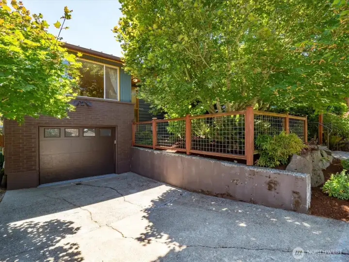 The one car garage is large and has an electric garage door while the driveway adds extra off street parking. The one car garage is large and has an electric garage door while the driveway adds extra off street parking.
