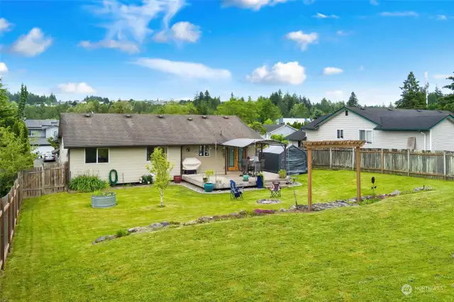 Flat back yard with space for gardening, pools, play structures, and more! Bring your imagination!