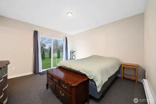 Primary bedroom with slider to back door